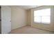 Bedroom with neutral carpet, light walls and a bright window at 5916 Longeria Ct, Raleigh, NC 27612