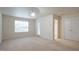 Spacious bedroom with a door to the outside, a large window, and an ample closet at 5916 Longeria Ct, Raleigh, NC 27612