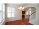 Bright dining room featuring hardwood floors and stylish chandelier lighting with access to the kitchen at 5916 Longeria Ct, Raleigh, NC 27612