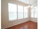 Dining room filled with natural light featuring hardwood flooring and a classic chandelier at 5916 Longeria Ct, Raleigh, NC 27612