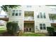 View of the townhouse exterior with a grill and seating on the back patio at 5916 Longeria Ct, Raleigh, NC 27612