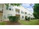 Townhouse exterior with back patios and balconies surrounded by green shrubs and lawn at 5916 Longeria Ct, Raleigh, NC 27612