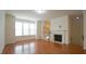 Inviting living area with fireplace, hardwood floors and abundant natural light at 5916 Longeria Ct, Raleigh, NC 27612