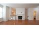 Cozy living room with a fireplace and an archway view to the kitchen at 5916 Longeria Ct, Raleigh, NC 27612