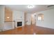 Open living area featuring a fireplace and an archway to a brightly lit kitchen at 5916 Longeria Ct, Raleigh, NC 27612