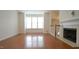 Bright and open living area with a fireplace, hardwood floors, and large windows at 5916 Longeria Ct, Raleigh, NC 27612