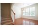 Light-filled dining room with hardwood floors, a staircase, and traditional chandelier at 5916 Longeria Ct, Raleigh, NC 27612