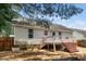 Home's back exterior with a wooden deck and stairs leading to the yard at 612 Agin Court Pl, Clayton, NC 27520