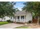 A well-maintained home with a covered front porch, a paved driveway, and neat landscaping at 612 Agin Court Pl, Clayton, NC 27520