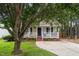 A cozy home featuring a welcoming front porch and a well-maintained lawn at 612 Agin Court Pl, Clayton, NC 27520