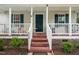 Charming front porch with a white railing, painted stairs, and dark shutters on the windows at 612 Agin Court Pl, Clayton, NC 27520