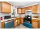 Efficient kitchen with wooden cabinets, modern appliances, and natural light at 612 Agin Court Pl, Clayton, NC 27520