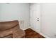 Cozy interior corner featuring a comfortable chair and a white interior door at 612 Agin Court Pl, Clayton, NC 27520