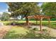 Backyard featuring a gazebo, grill, and a pergola situated in a well-manicured lawn at 6200 Us-401 S, Bunnlevel, NC 28323