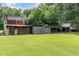 Rustic barn or outbuilding with a metal roof, surrounded by a large, grassy area at 6200 Us-401 S, Bunnlevel, NC 28323