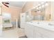 Bright bathroom with a clawfoot tub, double vanity, and natural light from a large window at 6200 Us-401 S, Bunnlevel, NC 28323