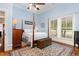 Cozy bedroom with hardwood floors, four-poster bed, and a warm, inviting atmosphere at 6200 Us-401 S, Bunnlevel, NC 28323