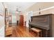 Inviting hallway with rich hardwood floors, and vintage piano that adds character to the home at 6200 Us-401 S, Bunnlevel, NC 28323