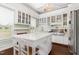 Bright, well-appointed kitchen featuring a center island, white cabinetry, and views to the outside at 6200 Us-401 S, Bunnlevel, NC 28323