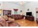 Inviting living room featuring hardwood floors, leather furniture, and a ceiling fan at 6200 Us-401 S, Bunnlevel, NC 28323