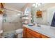 Well-lit bathroom featuring a glass-enclosed shower, vanity, and storage shelves at 6408 Glen Brack Ct, Raleigh, NC 27603
