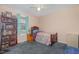 Cozy bedroom with a comfortable bed, bedside table, and a bookshelf by the window at 6408 Glen Brack Ct, Raleigh, NC 27603