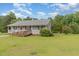 Charming single-story home with a gray exterior, front porch and spacious front yard at 6408 Glen Brack Ct, Raleigh, NC 27603