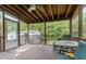Relaxing screened-in porch area with wood flooring, ceiling fan, and comfortable outdoor seating at 6408 Glen Brack Ct, Raleigh, NC 27603