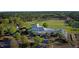 Sprawling golf clubhouse surrounded by lush greenery, a golf course, and ample parking at 6900 Staghorn Ln, Raleigh, NC 27615