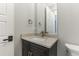 Powder room features a dark vanity cabinet, bronze faucet, and marbled countertop at 6900 Staghorn Ln, Raleigh, NC 27615