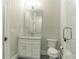 This bathroom features a vanity with stone countertop, toilet and glass shower at 6900 Staghorn Ln, Raleigh, NC 27615