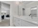 Bright bathroom featuring double vanity with white cabinets and marble countertop at 6900 Staghorn Ln, Raleigh, NC 27615