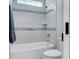 Bathroom featuring a soaking tub with light gray tiled walls and shower at 6900 Staghorn Ln, Raleigh, NC 27615