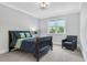Bedroom with a large window with a view of exterior trees and a black bed frame at 6900 Staghorn Ln, Raleigh, NC 27615