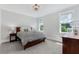 Cozy bedroom with large windows, hardwood floors, and comfortable bed at 6900 Staghorn Ln, Raleigh, NC 27615