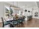 Elegant dining area with an oversized window, a large table, and modern light fixture at 6900 Staghorn Ln, Raleigh, NC 27615