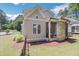 Rear exterior view of home featuring a screened in porch with a stone exterior and wood siding at 6900 Staghorn Ln, Raleigh, NC 27615