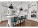 Bright kitchen features custom cabinets, an island with seating, and stainless steel appliances at 6900 Staghorn Ln, Raleigh, NC 27615