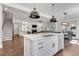 Open-concept kitchen features a large island, stainless steel appliances, and seamlessly connects to the living area at 6900 Staghorn Ln, Raleigh, NC 27615