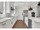 Chef's kitchen offers stainless appliances, custom cabinets, stone countertops, and a modern aesthetic at 6900 Staghorn Ln, Raleigh, NC 27615