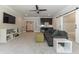 Living room features entertainment center, wet bar, gray sofa, and a sliding barn door at 6900 Staghorn Ln, Raleigh, NC 27615