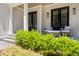 Inviting front porch with bluestone pavers and seating area with stylish chairs and pillows at 6900 Staghorn Ln, Raleigh, NC 27615