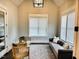 Bright sitting room with large windows, hardwood floors, and comfortable seating at 6900 Staghorn Ln, Raleigh, NC 27615