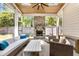 Sunroom featuring stone fireplace, wood ceiling, ceiling fan, and wicker furniture set at 6900 Staghorn Ln, Raleigh, NC 27615