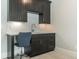 Wet bar featuring dark cabinets, granite countertop, subway tile backsplash and a chair at 6900 Staghorn Ln, Raleigh, NC 27615