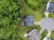A bird's-eye view of a home's roof, lawn, and surrounding green landscape and neighboring houses at 7502 Latteri Ct, Raleigh, NC 27613