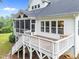 An elevated back porch featuring stairs leading to the backyard and a screened-in section at 7502 Latteri Ct, Raleigh, NC 27613