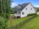 Expansive backyard with a screened deck, fenced perimeter, and lush green lawn at 7502 Latteri Ct, Raleigh, NC 27613