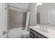 Clean bathroom features a shower and tub combination plus a dark vanity with a white basin at 7502 Latteri Ct, Raleigh, NC 27613