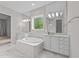 Elegant bathroom with dual vanities, soaking tub, and marble flooring at 7502 Latteri Ct, Raleigh, NC 27613